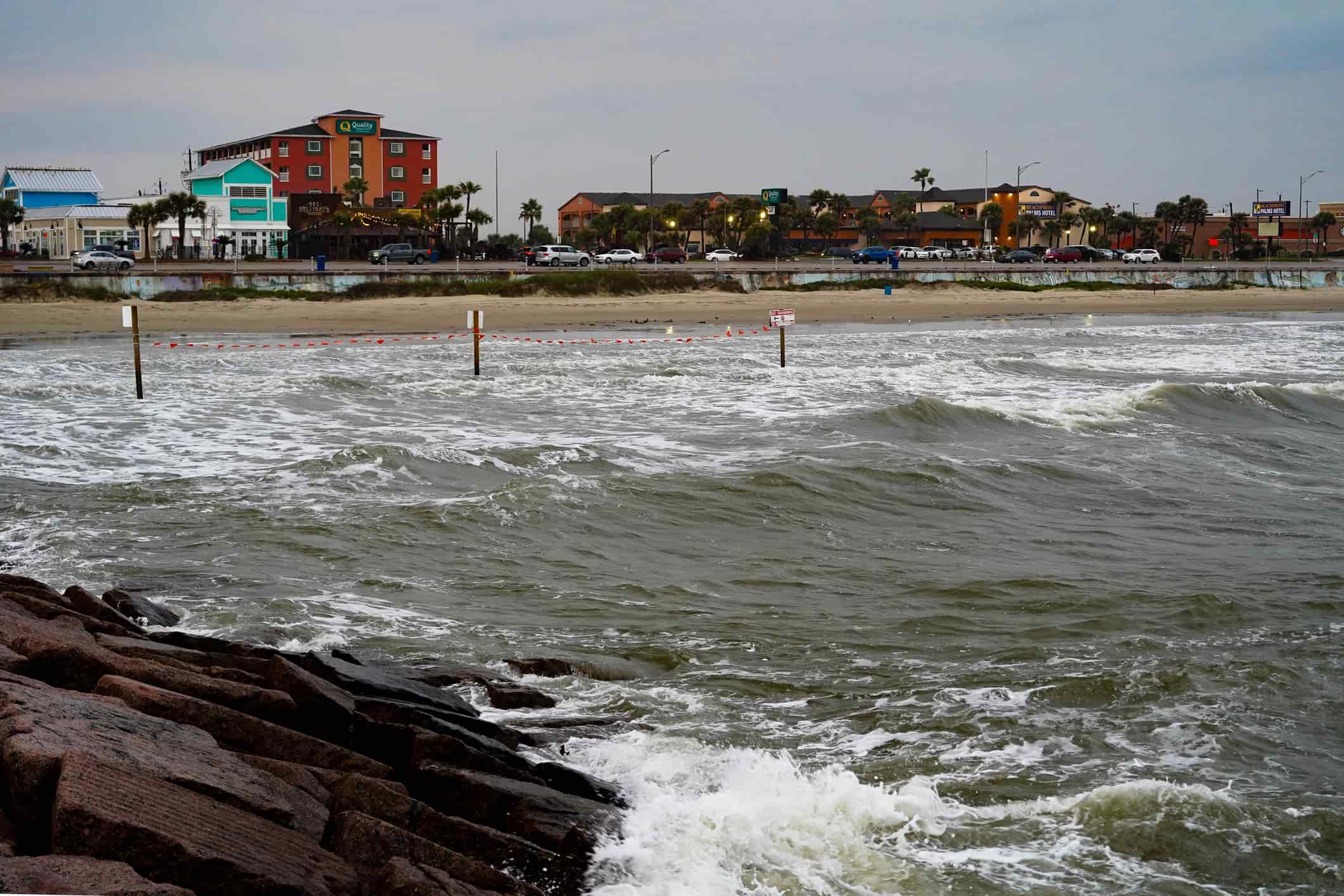 View from the Gulf of Mexico of the beach, seawall, restaurants and hotels on the Strand, Galveston, Texas, USA