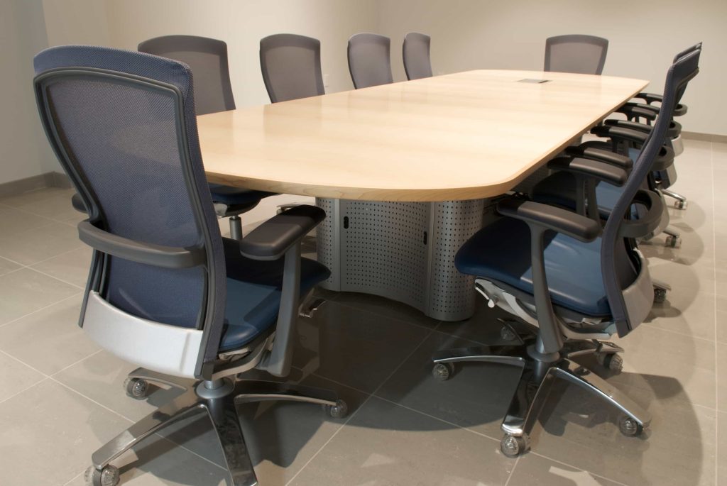 Sleek modern conference table is surrounded by enough chairs for a board of directors